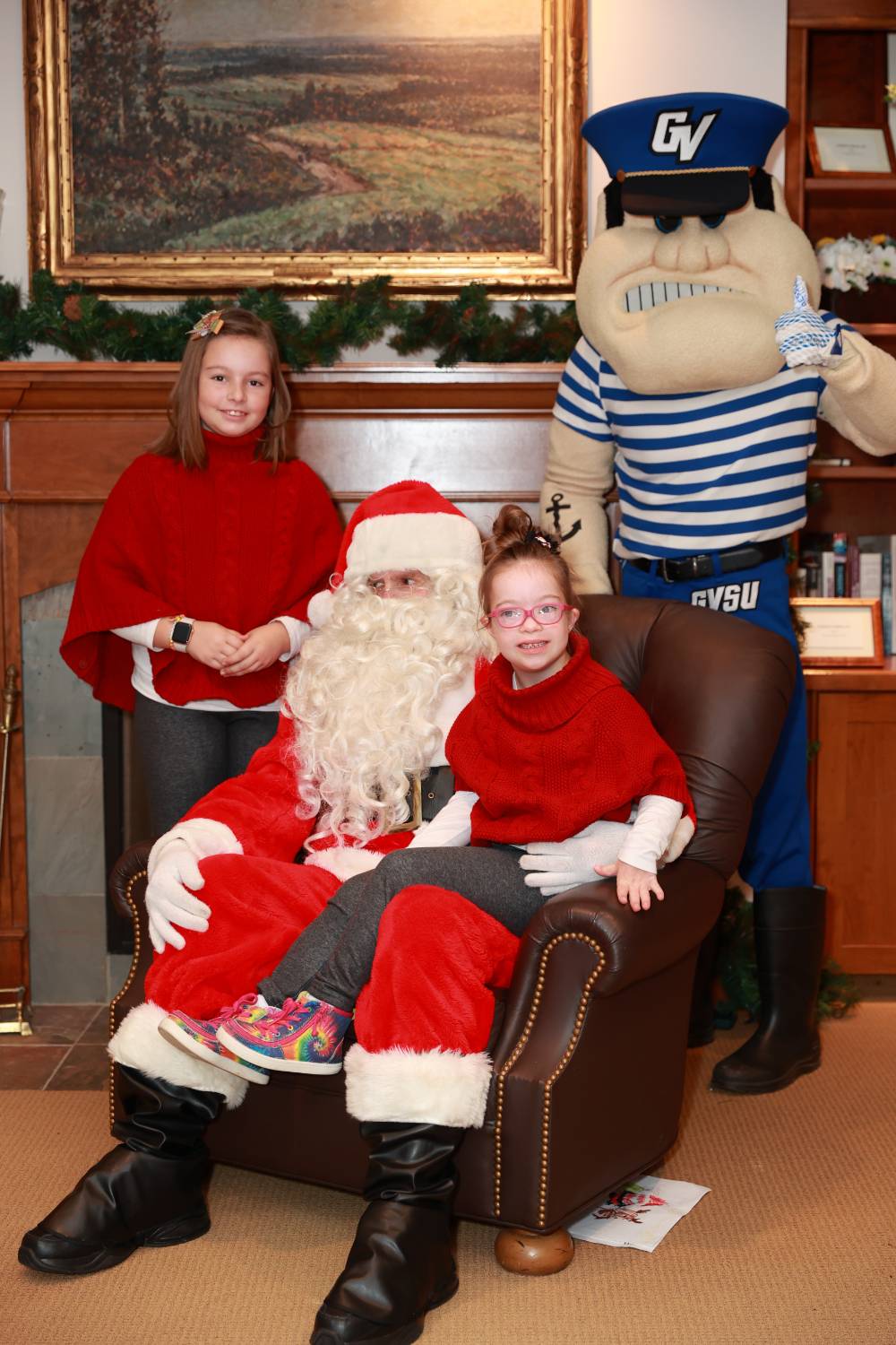 Two sisters with Santa & Louie at the event.